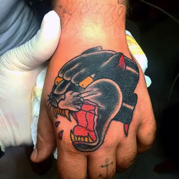 Traditional panther head tattoo on the inner forearm