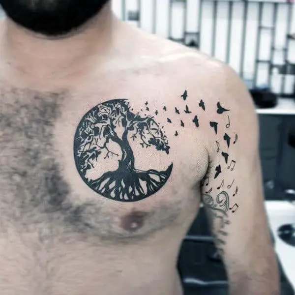 circular-tree-roots-with-birds-mens-chest-tattoo