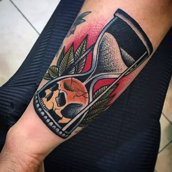 guys-traditional-hourglass-skull-outer-forearm-old-school-tattoo