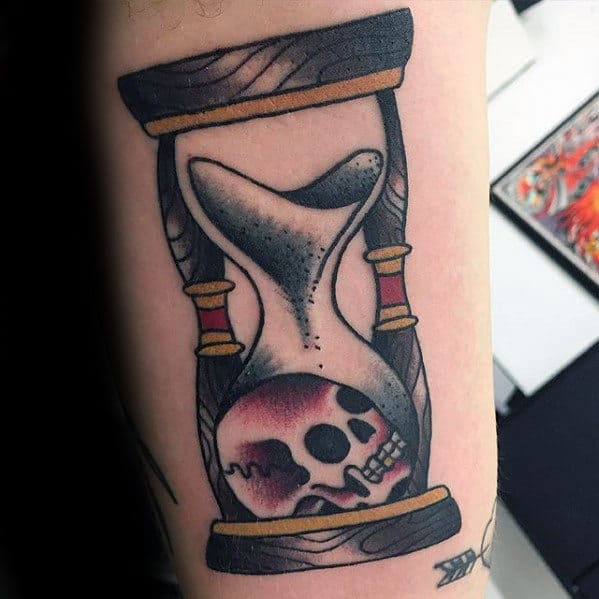 sand-and-skull-inside-hourglass-guys-traditional-inner-arm-bicep-tattoo