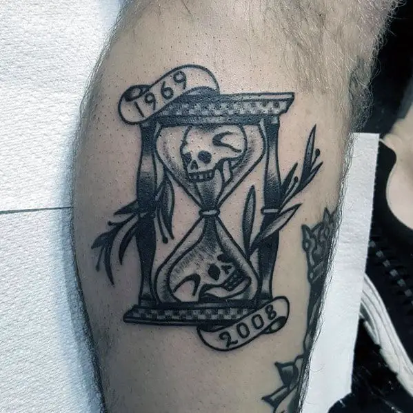 shaded-black-and-grey-traditional-hourglass-skull-tattoos-for-men-on-leg