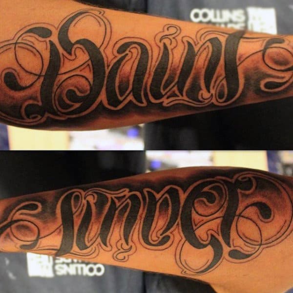 man-with-saint-sinner-ambigram-tattoo-on-arm