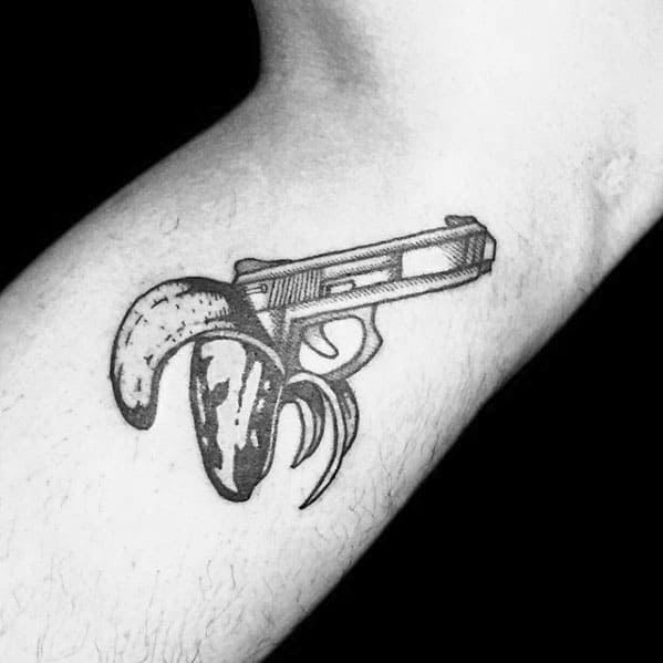 guy-with-pistol-banana-tattoo-design