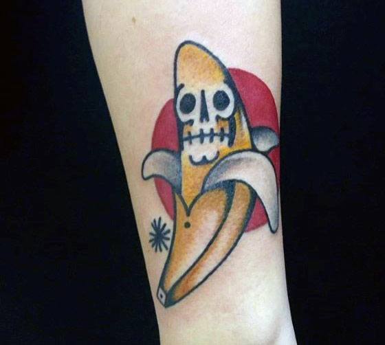 mens-tattoo-ideas-with-skull-banana-and-red-sun-design-on-forearm