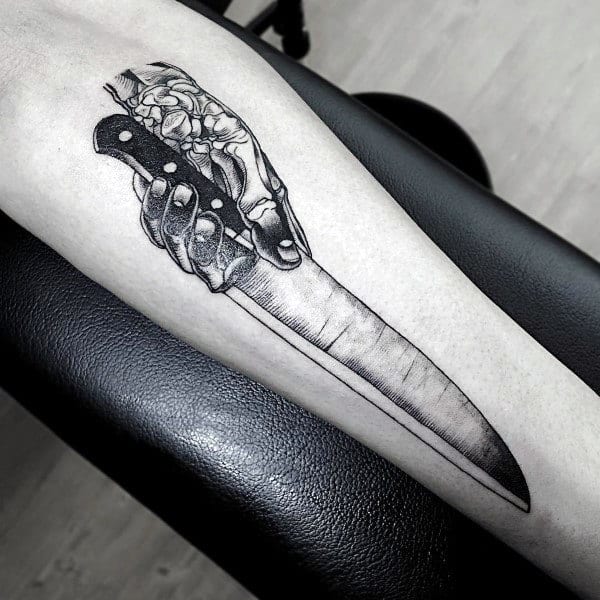 skeleton-hand-holding-chef-knife-mens-forearm-tattoo