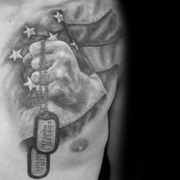 man-with-hand-holding-dog-tags-memorial-fallen-soldier-chest-tattoo