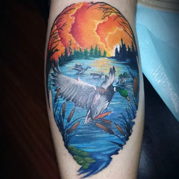 duck-flying-over-water-sunset-background-tattoo-for-guy