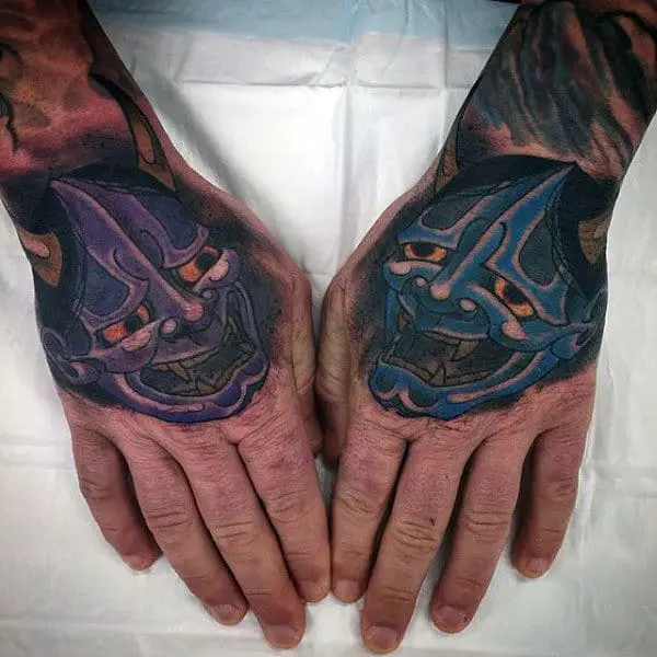 blue-and-purple-hannya-masks-tattoos-on-mans-hands