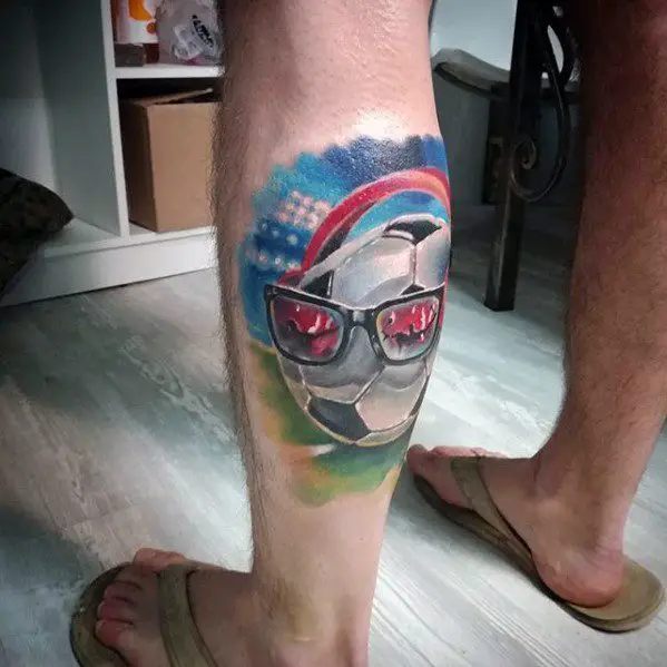 male-tattoo-with-sports-design-on-leg-calf