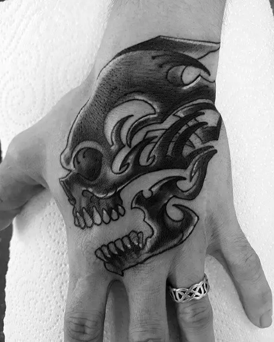 black-ink-hand-male-tribal-skull-tattoo-designs