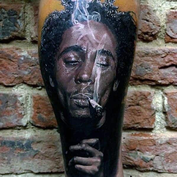 Bob Marley portrait tattoo located on the thigh,