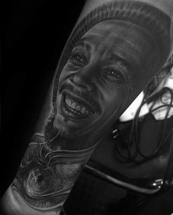 shaded-black-and-grey-bob-marley-tattoo-on-guys-forearm