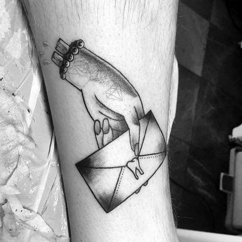 leg-hand-with-envelope-mens-tattoo-designs