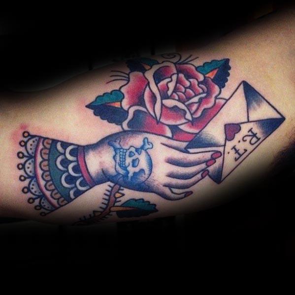 male-envelope-rose-flower-with-hand-traditional-bicep-inner-arm-tattoo-designs