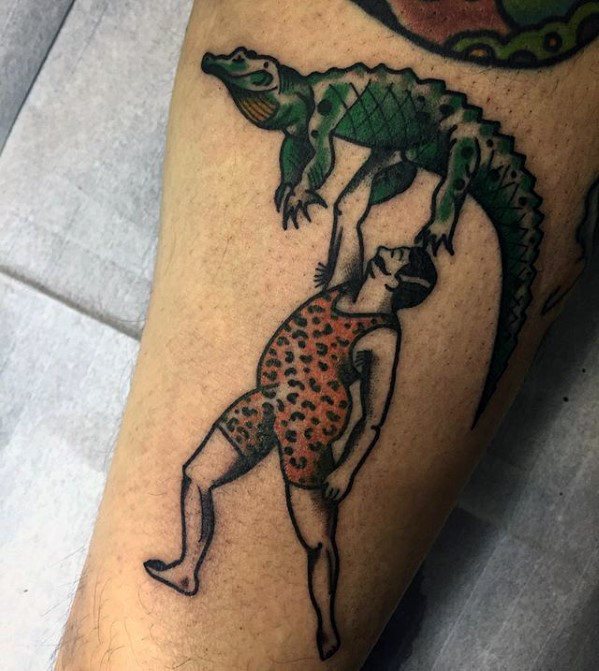 circus-man-lifting-up-alligator-leg-guys-tattoos