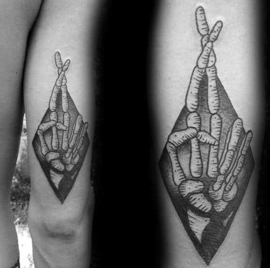crossed-skeleton-hand-fingers-mens-good-luck-tattoo-design-inspiration