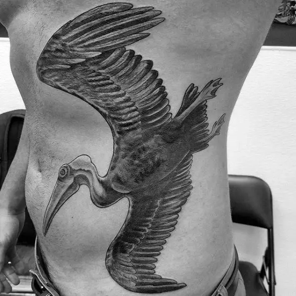 mens-tattoo-black-and-grey-ink-flying-pelican-design-full-rib-cage-side