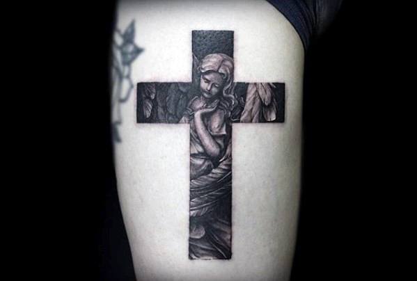 gentleman-with-small-religious-angel-cross-tattoo-on-thigh
