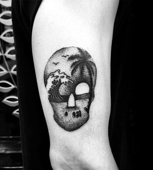 skull-with-beach-landscape-guys-arm-tattoo