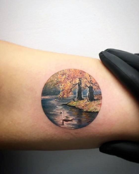 arm-mens-fall-leaves-with-river-small-colorful-tattoo