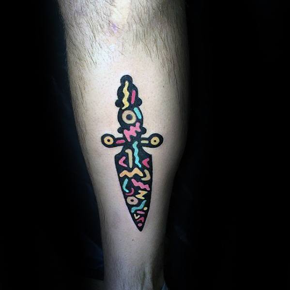 gentleman-with-dagger-and-shapes-small-colorful-back-of-leg-tattoo