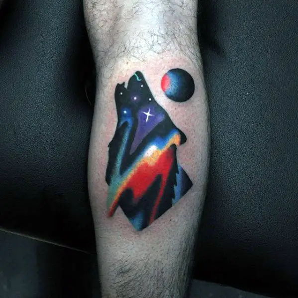 howling-wolf-with-moon-small-colorful-night-sky-mens-leg-calf-tattoo