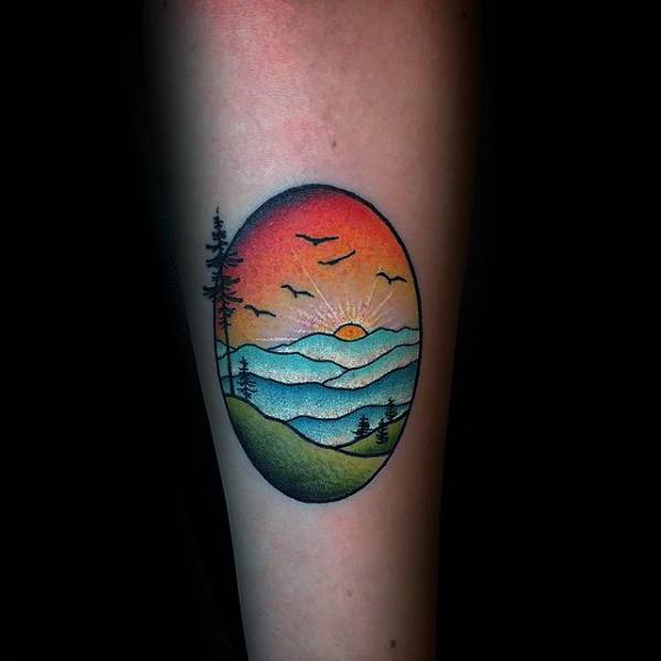 rising-sun-with-nature-scene-guys-small-colorful-forearm-tattoo
