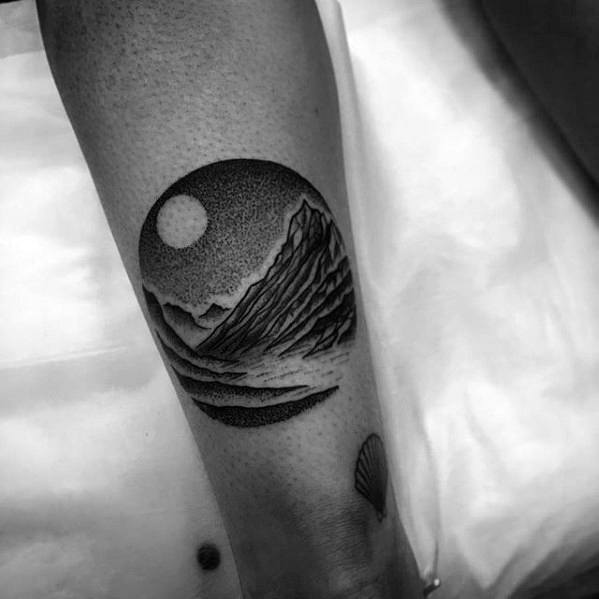 circle-dotwork-guys-moon-in-sky-with-mountains-small-back-of-leg-tattoo