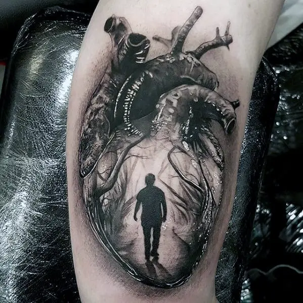 black-and-grey-man-walking-in-anatomical-heart-mens-realistic-arm-tattoo