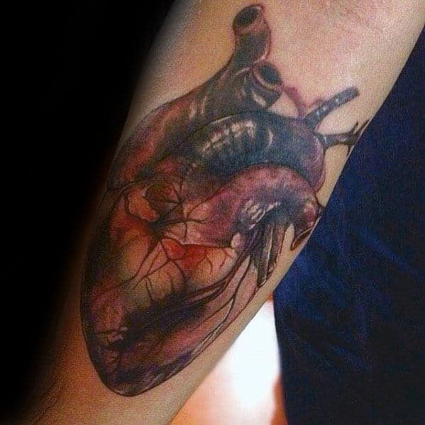 guy-with-realistic-heart-tattoo-design-on-inner-forearm