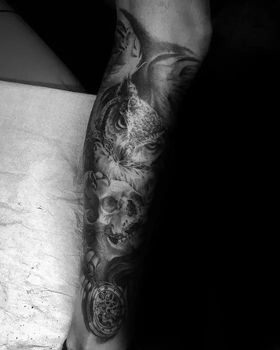 leg-sleeve-tattoo-owl-holding-onto-skull-for-men