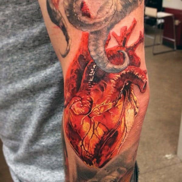 realistic-male-heart-tattoo-design-on-outer-arm