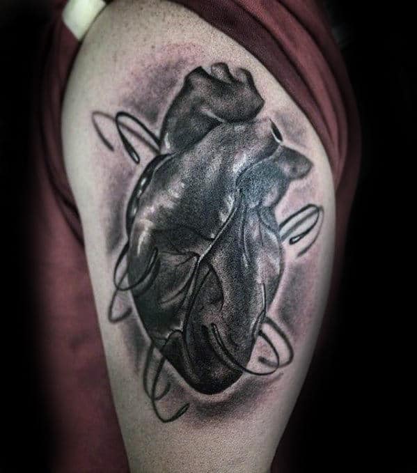 thigh-guys-unique-fish-hook-anatomical-heart-tattoo-with-realistic-design